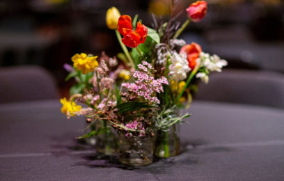 Image of wildflowers in a vase on a dark grey tablecloth