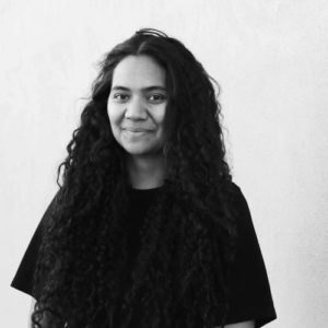 black and white image of a woman with long hair and black tshirt and whit background