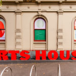 Arts House - Bryony Jackson - I am here, You are there, I miss you - Building with three windows and large red letters that say "Arts House" in front